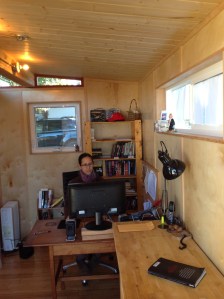 Maya Churi sits inside this 8' by 15' Modern-Shed.