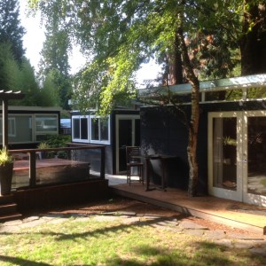 A 10' by 12' studio sits next to the 12' by 16' guest suite, blending with the couple's home in the background.